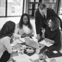 people around a table discussing operations