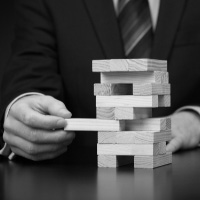 Risk management, controls, and regulatory compliance shows through jenga.